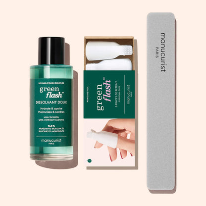 The Manucurist-us Green Flash™ Remover  Clips Duo, featuring plant-based remover, two white removal clips, and a gray nail file, is displayed on a light pink background.