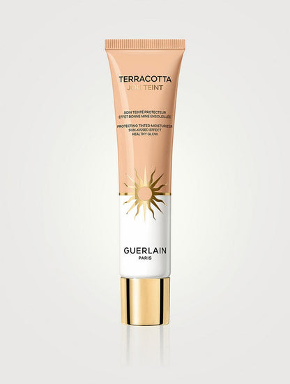 Guerlain Terracotta Joli Teint tinted moisturizer in shade NIB, providing a natural, glowing finish with light protection.