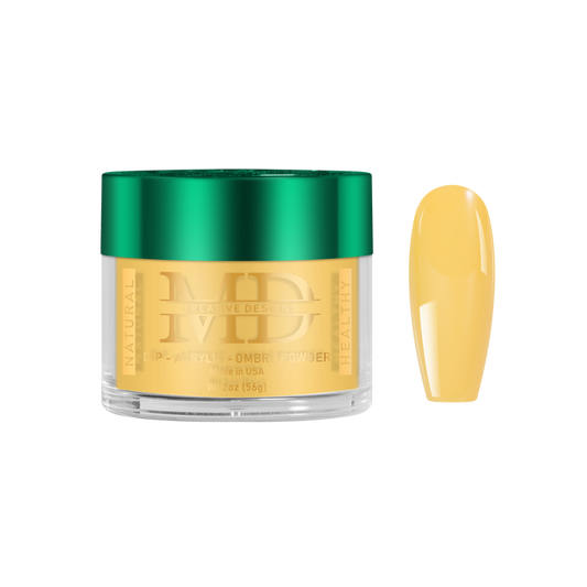 Gold-colored powder in a jar with a green lid, next to a yellow nail color swatch on a white background.