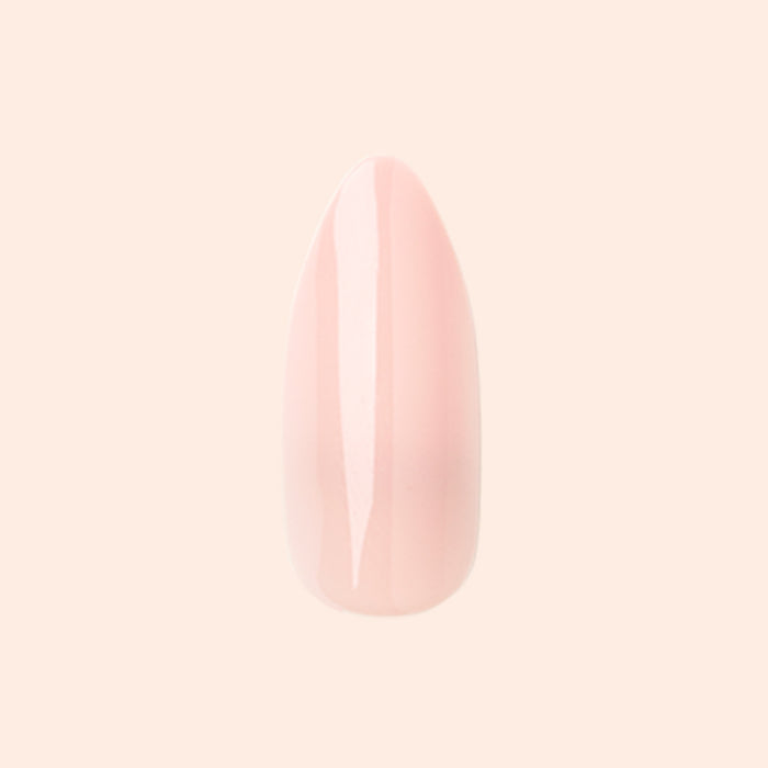 KAG - Press-On | Long | Almond showing a single long almond press-on nail in soft neutral peachy pink polish