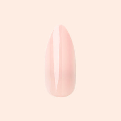 KAG - Press-On | Long | Almond showing a single long almond press-on nail in soft neutral peachy pink polish