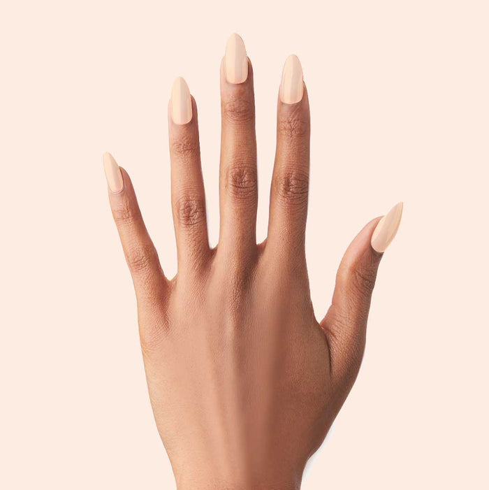 KAG - Press-On | Long | Almond showing hand with long almond press-on nails in soft neutral peachy pink polish