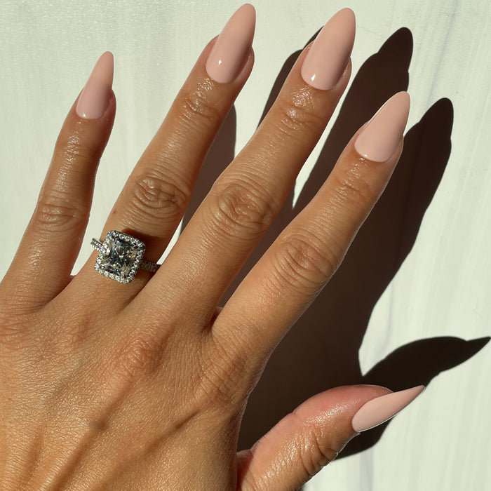 KAG - Press-On | Long | Almond showing hand with long almond false nails in neutral peachy pink polish in natural light