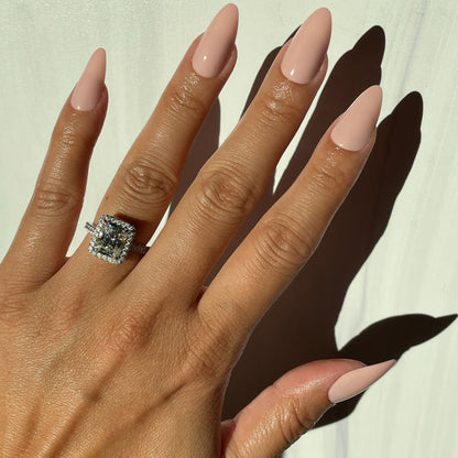 KAG - Press-On | Long | Almond showing hand with long almond false nails in neutral peachy pink polish in natural light