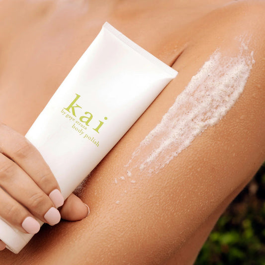 Kai body polish tube with exfoliating foam on arm