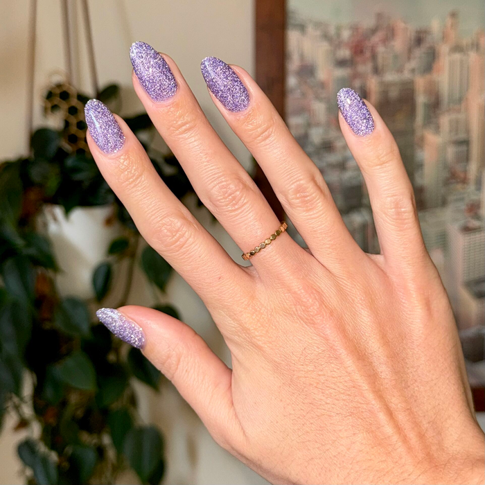Natural nails with Karaoke is a Good Time Gel purple flash glitter polish for a vibrant and long-lasting manicure
