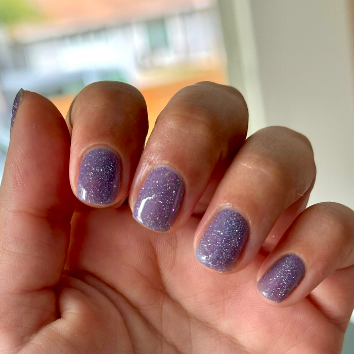 Nails painted with Karaoke is a Good Time Gel showing purple glitter gel polish for a sparkling mani look
