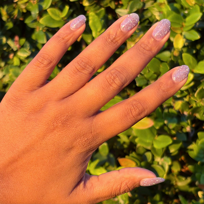 Natural nails with shimmering purple flash glitter polish using Karaoke is a Good Time Gel for a sparkling mani look
