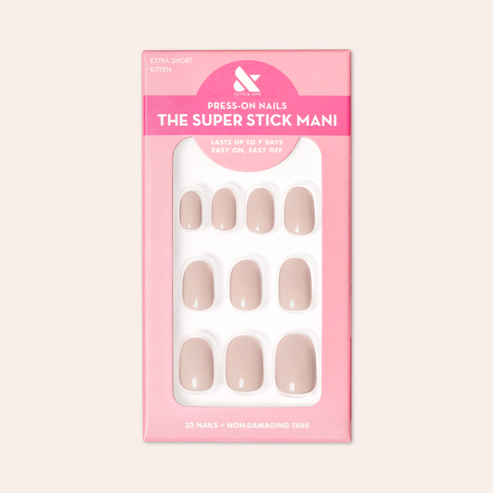 Kitten | Extra Short | Round - Tab Press-On showing neutral grey beige false nails in pink packaging against pale background
