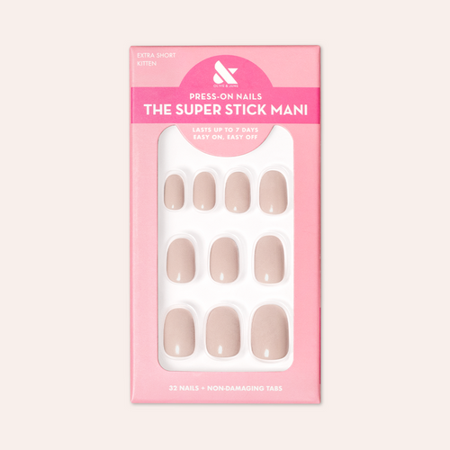 Kitten | Extra Short | Round - Tab Press-On showing neutral grey beige false nails in pink packaging against pale background