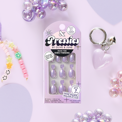 La La Lavender Chrome - Pressies | Extra Short Short | Round showing lavender chrome press on nails in packaging with kids accessories on lilac background