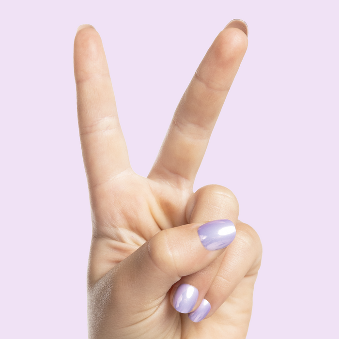 La La Lavender Chrome - Pressies | Extra Short Short | Round showing hand with lavender chrome press on manicure nails on light purple background