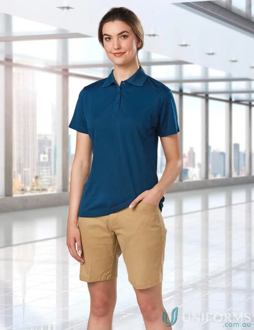 Lady wearing Ladies Stretch SlimFit Boston Shorts in blue polo and khaki shorts
