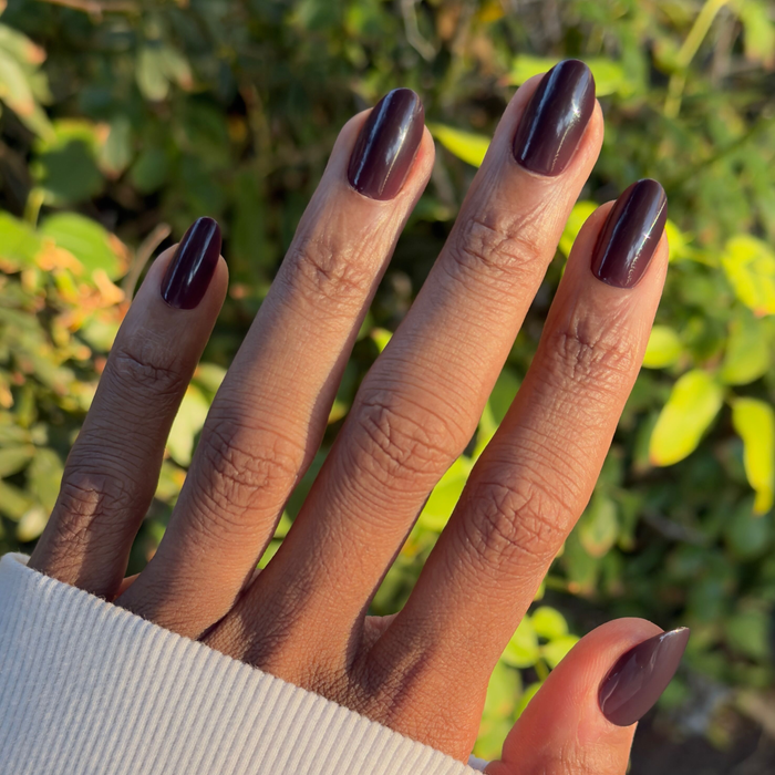 Let’s Stay In - Press-On | Medium | Oval in a deep maroon-brown shade on natural nails for a cozy mani