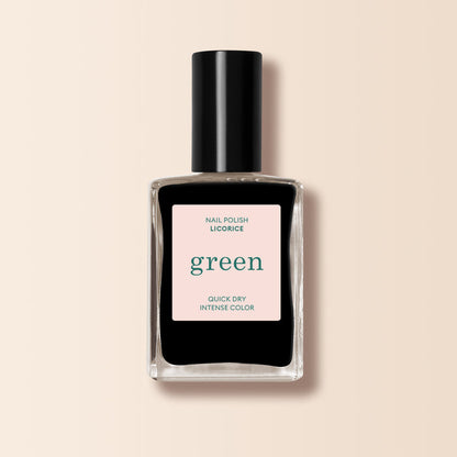 A bottle of Manucurist Licorice nail polish from the Green™ range, featuring a clear rectangular bottle with deep black polish and a black cap, is set against a light beige background.