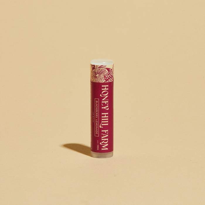 Lip balm tube with red label and white cap