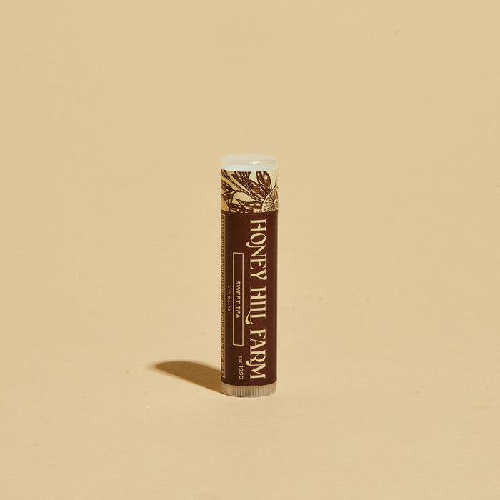 Lip balm tube with brown label and white cap