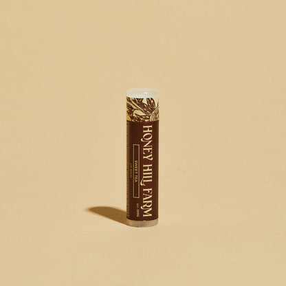 Lip balm tube with brown label and white cap