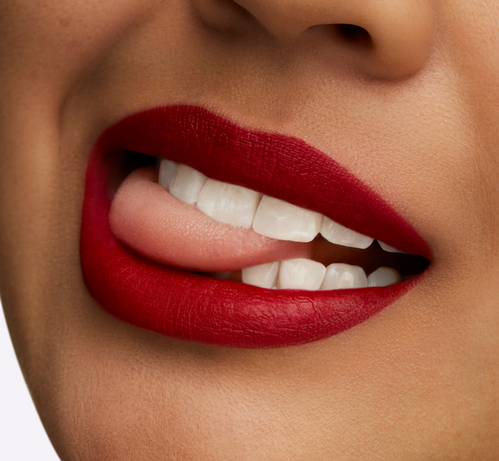 M.A.C Retro Matte Lipstick in Ruby Woo, vibrant red shade, with the lipstick tube and packaging visible in the image.