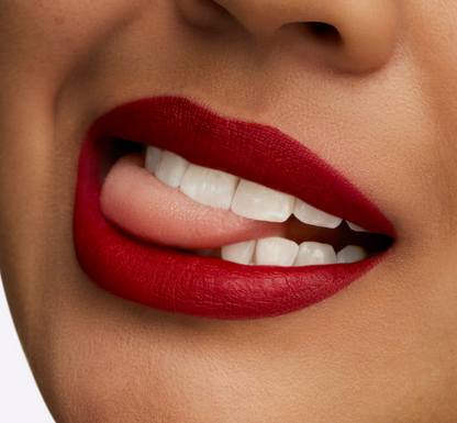 M.A.C Retro Matte Lipstick in Ruby Woo, vibrant red shade, with the lipstick tube and packaging visible in the image.