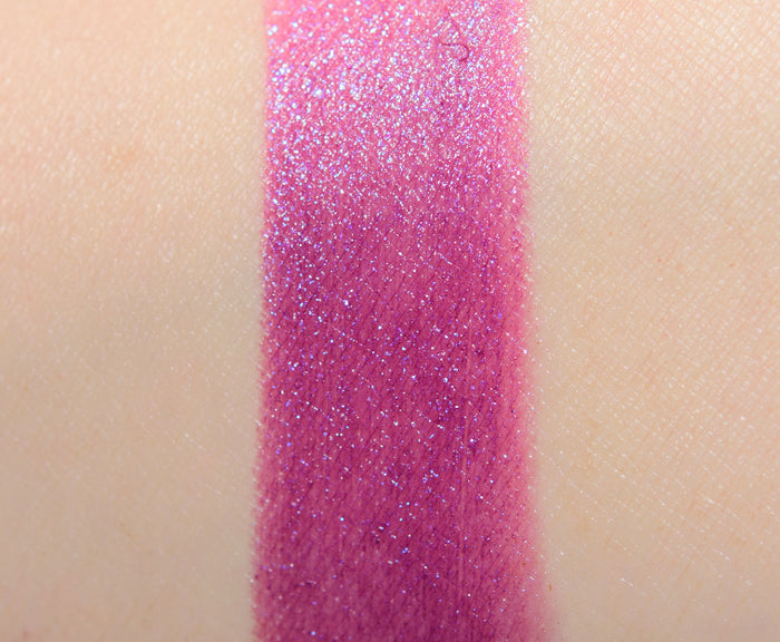 M.A.C x Teyana Taylor beauty product with two shade swatches on skin, showcasing makeup colors in a natural light.