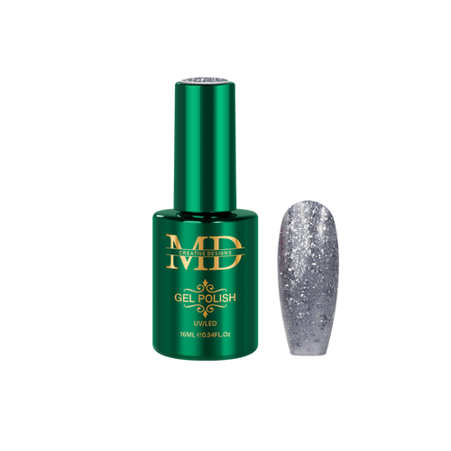 Green gel polish bottle with gold text and a glittery silver nail tip next to it on a white background
