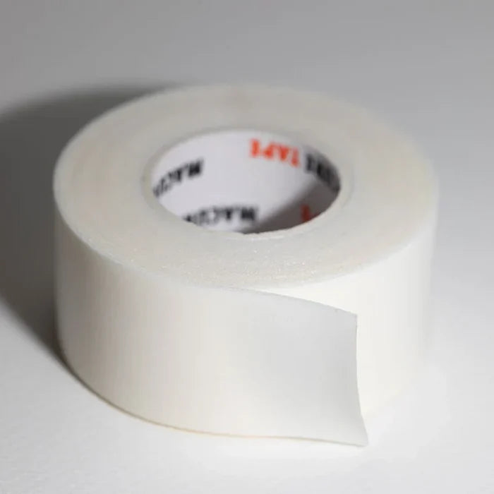 A roll of white microporous foam tape with a partially peeled strip featuring the 3m brand logo on the inner core