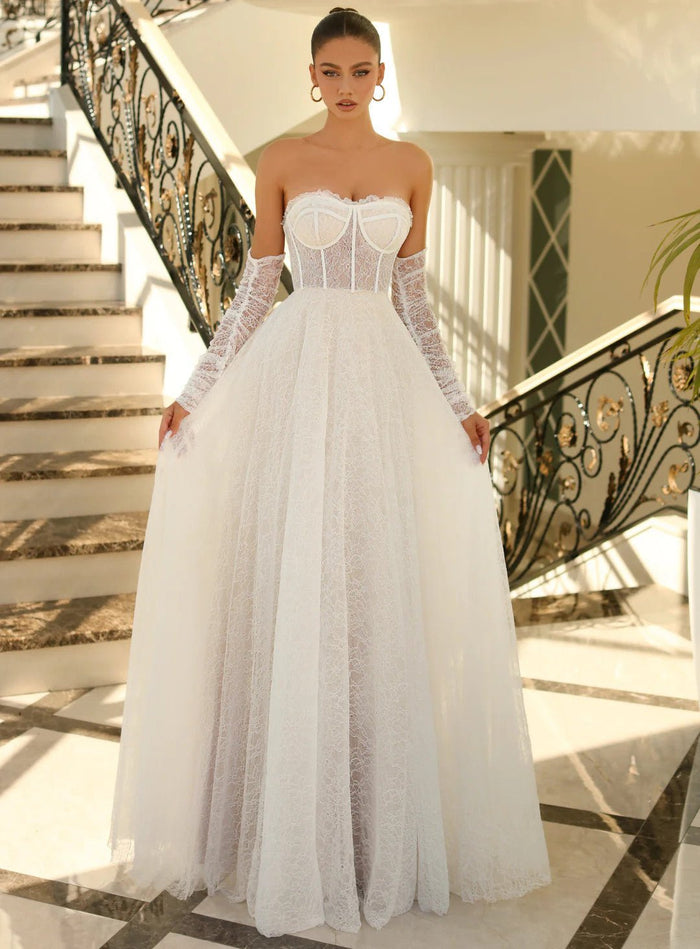 Ivory strapless lace ballgown NC1005 with corset bodice and sheer lace gloves, ideal for bridal or formal occasions. Elegant wedding dress on sale.