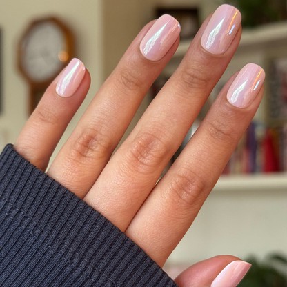 Hand showing Pink Sands Chrome - Tab Press On | Short | Squoval nails in cool pastel pink with chrome shimmer indoors