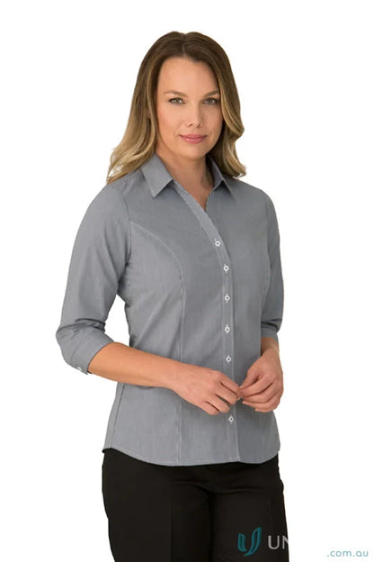 Woman in Pippa Check princess line workwear uniform with gray fitted shirt and black pants