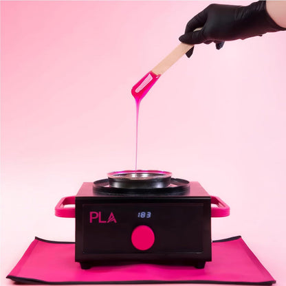 Person using a stick to get pink wax from a black and pink wax pot labeled 'PLA' on a pink background.