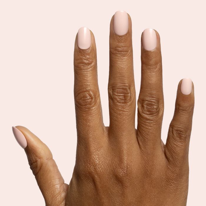 Pointe | Extra Short | Round - Tab Press-On soft ballerina pink press-on nails styled on hand with neutral background