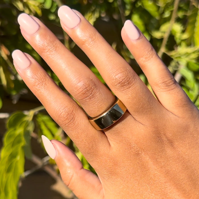 Pointe | Extra Short | Round - Tab Press-On soft ballerina pink press-on mani displayed on hand outdoors with gold ring