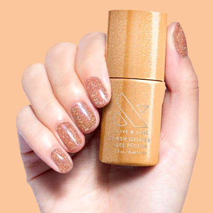 Pop Fizz Mani Gel on nails and bottle showing sparkling yellow gold glitter polish for at-home manicure use