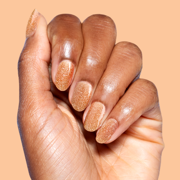 Pop Fizz Mani Gel applied on natural nails showing sparkling yellow gold glitter polish for at-home manicure use