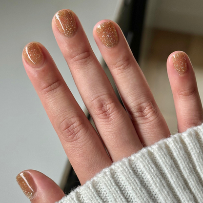 Pop Fizz Mani Gel applied on nails showing shimmering yellow gold glitter polish for long-lasting at-home manicures