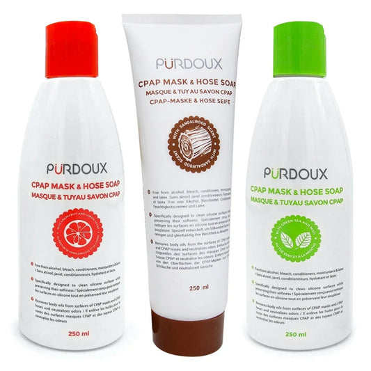 Three bottles of Purdoux CPAP mask and hose soap with different colored caps on a white background.