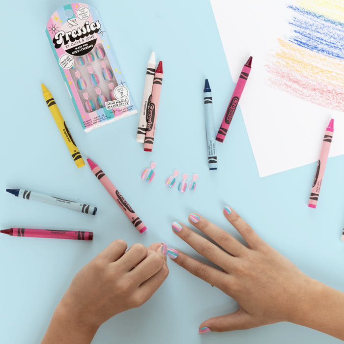 Rainbow Super Stripes - Pressies | Extra Short Short | Round showing kid applying colorful striped press on nails with crayons nearby