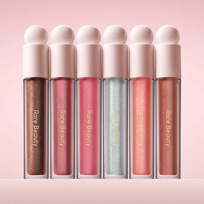 Rare Beauty Positive Light Luminizing Lip Gloss in various shades, featuring glossy, radiant finish and smooth application.