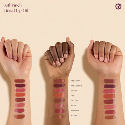 Rare Beauty Soft Pinch Tinted Lip Oil Stain in various shades, featuring a sleek applicator and vibrant, glossy finish.