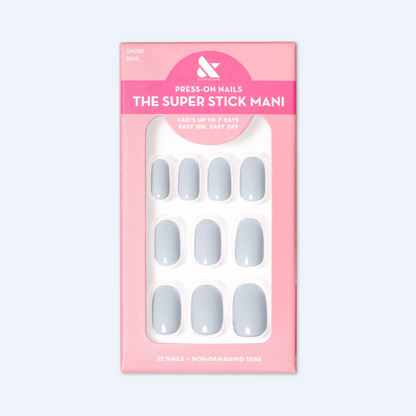 Rink | Short | Round - Tab Press-On icy blue false nails with smooth finish displayed in pink packaging box