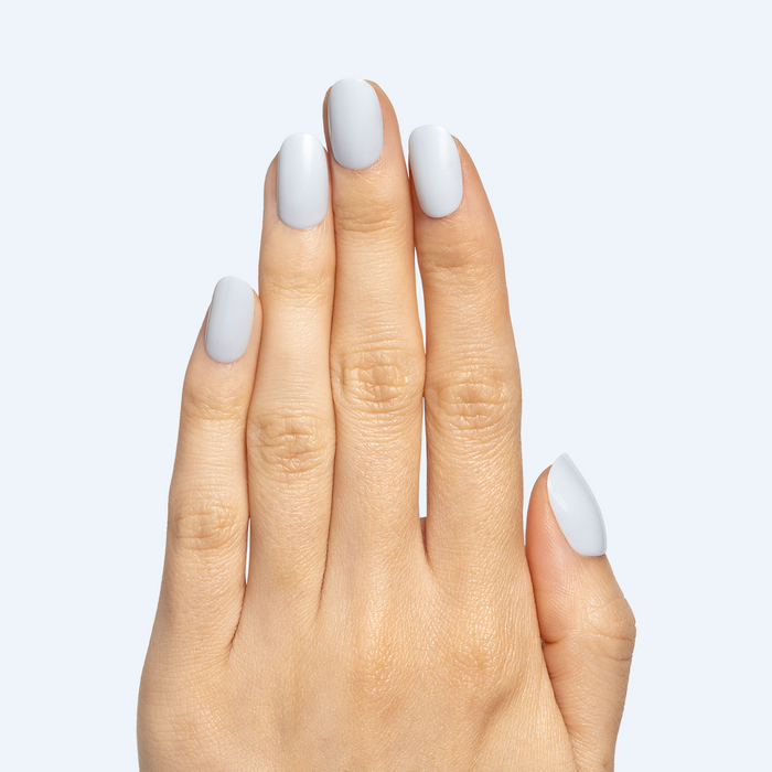 Rink | Short | Round - Tab Press-On icy blue false nails shown on hand with smooth, glossy manicure finish