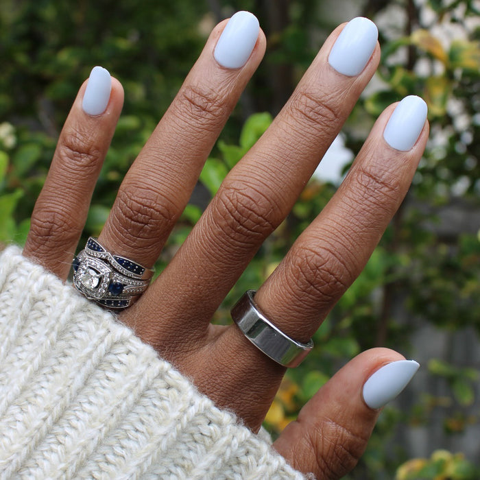 Rink | Short | Round - Tab Press-On icy blue press-on nails on hand wearing silver and gemstone rings outdoors