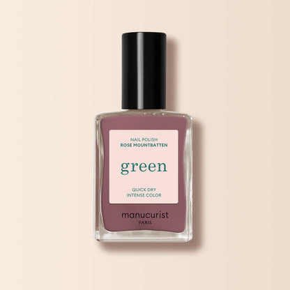 A bottle of Manucurist Rose Mountbatten nail polish, a pinky taupe shade from the Green™ range, featuring a black cap and a green label on a light beige background.