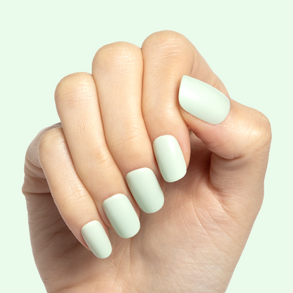 Seafoam | Short | Squoval - Tab Press-On soft pastel green press-on nails on hand with natural light background