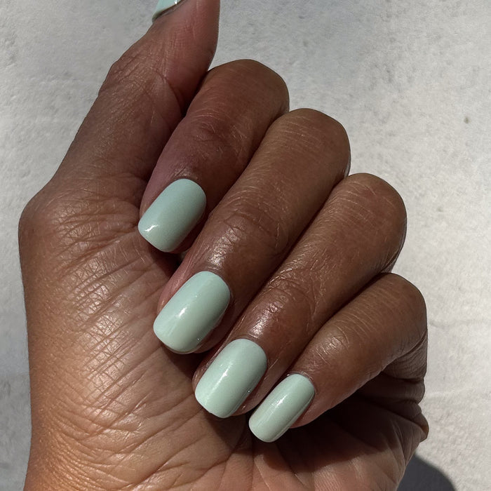 Seafoam | Short | Squoval - Tab Press-On pastel green press-on nails with smooth glossy finish on hand in natural light