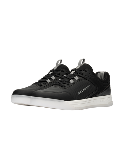 Three-quarter view of Selkirk Legacy Pro pickleball shoes with InfiniGrip, black uppers, white soles, and Selkirk branding
