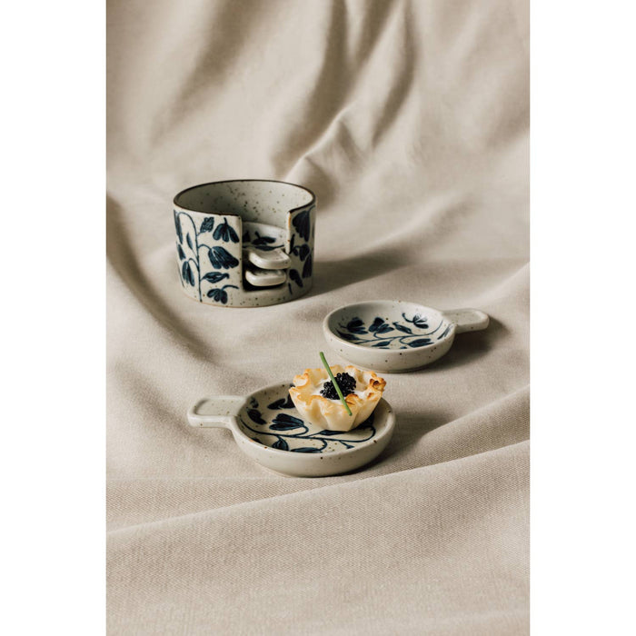 Amuse bouche plate set of four, off-white ceramic with blue posy floral, on cloth