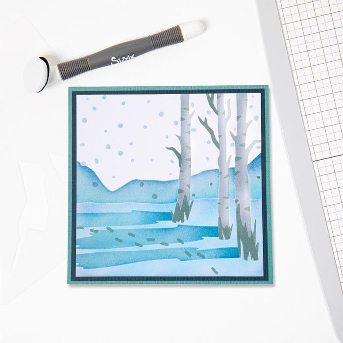 Sizzix - Making Tool Layered Stencil 6"X6" By Olivia Rose - Winter Scenes. Brrr! What a chilly scene, with bare birch trees, flakes falling and deep footprints in the snow this Winter Scene Layered Stencil is perfect for a wintery backdrop. Available at Embellish Away located in Bowmanville Ontario Canada.