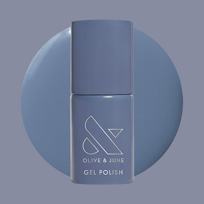 Olive and June Slate - Gel polish bottle with deep midtone slate blue gel polish swatch behind it on muted background